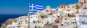 Paisaje de Santorini con la bandera griega. Imagen que ilustra el artículo "Grecia con Carné Joven".